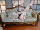 A woman laying on a couch with her legs up.