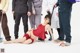 A woman in a red dress is laying on the ground.