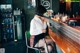 A woman sitting at a bar with her legs crossed.